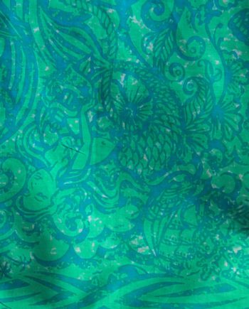 aqua and turquoise cotton sarong or beach cover up with a tattooed design of mermaids and sea creatures. Close up