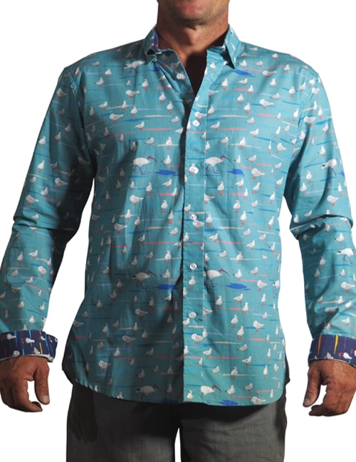 men's fitted 100% indian cotton long sleeved shirt printed with a design of seagulls and bin chickens on a aqua blue background with contrasting cuff and placket