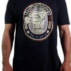180-gram black cotton t-shirt printed with a beer label in cream and brown of a hand holding a stein with the image of the front of a Kombi van with froth spilling over. "Volkslager das ist gut ja" features around the beer bstein.